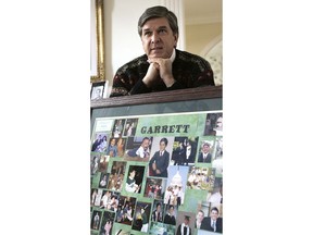 FILE - In this March 18, 2006 file photo, Sen. Gordon Smith, R-Ore., sits at his Pendleton, Ore., home behind a photo collage of his son, Garrett, who took his life in 2003. His suicide led to the creation of a federal grant, which has awarded $76 million for prevention programs to more than 230 colleges since 2005, on top of millions that institutions have spent on their own.