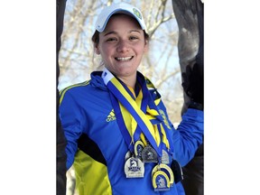 FILE - In this Feb. 27, 2015, file photo, Becca Pizzi poses in Newton, Mass., wearing some of her medals from the 15 Boston Marathons she has completed. Pizzi, from Belmont, Mass., completed the World Marathon Challenge -- seven marathons in seven days on seven continents -- in January 2016. She is preparing to tackle the odyssey again beginning on Jan. 30, 2018. If she completes it, she'll become the first to repeat the feat.