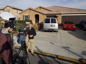 Members of the media work outside a home Tuesday, Jan. 16, 2018, where police arrested a couple on Sunday accused of holding their 13 children captive, in Perris, Calif. Authorities said an emaciated teenager led deputies to the California home where her 12 brothers and sisters were locked up in filthy conditions, with some of them malnourished and chained to beds.