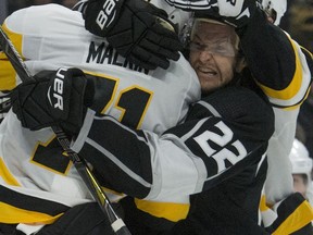 Los Angeles Kings Trevor Lewis (22) gets in a shoving match with Pittsburgh Penguins' Evgeni Malkin (71) during an NHL hockey game Thursday, Jan. 18, 2018, in Los Angeles.