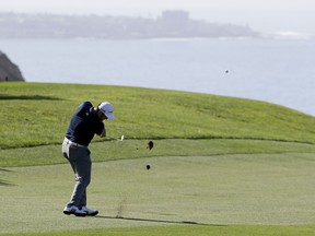 Jon Rahm hits from the fairway on the 14th hole hole of the North Course at Torrey Pines Golf Course during the second round of the Farmers Insurance Open golf tournament Friday, Jan. 26, 2018 in San Diego.