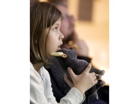 In this Tuesday, Dec. 19, 2017 photo, Haley Jay, 8, watches "Ferdinand" at Children's Hospital Orange County in Orange, Calif. Far away from the starry happenings Sunday, Jan. 7, 2018, around the Golden Globe Awards, this recent screening of "Ferdinand" at a local children's hospital is among hundreds each year made possible by the profitability of the annual awards show. The Hollywood Foreign Press Association has been sharing spoils from the Globes' international broadcast with arts-oriented nonprofits for 30 years.