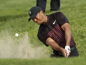 Tiger Woods hits out of a bunker on the ninth hole of the South Course at Torrey Pines Golf Course during the first round of Farmers Insurance Open golf tournament Thursday, Jan. 25, 2018, in San Diego.