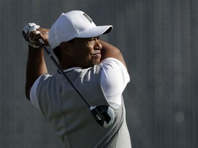 Tiger Woods watches his tee shot on the 10th hole of the South Course at Torrey Pines Golf Course during the third round of the Farmers Insurance Open golf tournament, Saturday, Jan. 27, 2018, in San Diego.