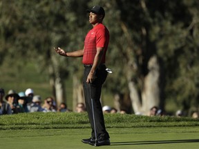 Tiger Woods reacts after missing a putt on the 13th hole of the South Course at Torrey Pines Golf Course during the final round of the Farmers Insurance Open golf tournament, Sunday, Jan. 28, 2018, in San Diego.