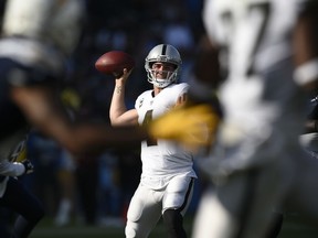 Oakland Raiders quarterback Derek Carr throws a pass during the first half of the team's NFL football game against the Los Angeles Chargers, Sunday, Dec. 31, 2017, in Carson, Calif.