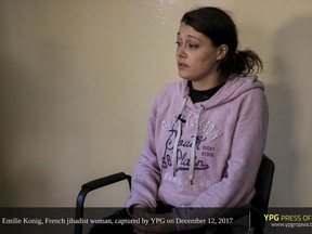 This photo released on Wednesday, Jan. 10, 2018 by the YPG press office of the Kurdish People's Protection Units shows French national Emilie Konig in a video. Konig is one of two notorious French Islamic State members with roots in Europe's networks of violent extremists are appearing on video with nearly identical messages, insisting they insisting they are being treated well by the Kurdish forces jailing them. (YPG press office via AP)