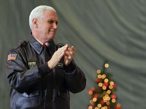 FILE - In this Thursday, Dec. 21, 2017 file photo, U.S. Vice President Mike Pence speaks to troops in a hangar at Bagram Air Base in Afghanistan. Israel's Foreign Ministry said Monday Jan. 1, 2018 that an expected visit by Pence has been postponed again. Pence was scheduled to visit Israel in December 2017.