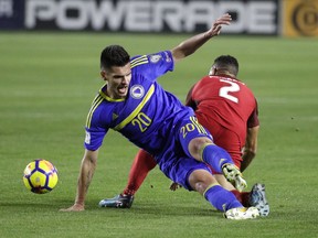 Bosnia and Herzegovina midfielder Goran Zakaric, left, and United States defender Justin Morrow tumble as they fight for the ball during the first half of an international friendly soccer match on Sunday, Jan. 28, 2018, in Carson, Calif.