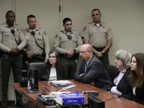 FILE--In this Jan. 18, 2018, file photo, defendants Louise Anna Turpin, left, with attorney Jeff Moore, and David Allen Turpin, right, with attorney Allison Lowe, appear in court for their arraignment in Riverside, Calif. More than $120,000 has been donated to help 13 siblings in California who authorities say were kept chained to beds for months by their parents, the Turpins, and starved so much that their growth was stunted.