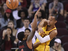 Southern California guard Jordan McLaughlin, right, passes the ball as Utah guard Justin Bibbins defends during the first half of an NCAA college basketball game, Sunday, Jan. 14, 2018, in Los Angeles.