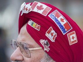 A man wears patriotic stickers on his turban as he participates in the annual Canada Day parade in Montreal, Friday, July 1, 2016.