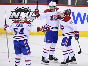 Paul Byron, left, celebrates his goal with Canadiens teammates Max Pacioretty, centre, and Charles Hudon during the third period of their game against the Capitals in Washington on Friday night.. The Canadiens won 3-2..
