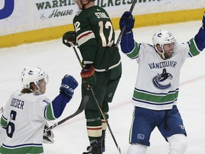 Vancouver Canucks Thomas Vanek, right, reacts with teammate Brock Boeser after Vanek scored a goal to tie the game in the third period against the Minnesota Wild Sunday in St. Paul, Minn. Vancouver won in overtime 3-2.