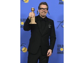 Gary Oldman poses in the press room with the award for best performance by an actor in a motion picture - drama for "Darkest Hour" at the 75th annual Golden Globe Awards at the Beverly Hilton Hotel on Sunday, Jan. 7, 2018, in Beverly Hills, Calif.