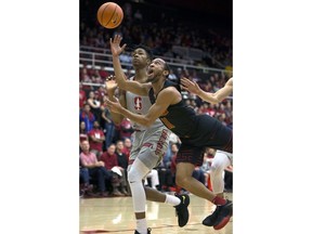 Southern California's Jordan McLaughlin (11) shoots in front of Stanford's Kenzie Okpala (0) during the first half of an NCAA college basketball game Sunday, Jan. 7, 2018, in Stanford, Calif.