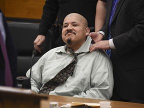 Luis Bracamontes waits for his trial to resume as his attorney places a necktie around his neck after a morning break in Sacramento Superior Court on Tuesday, Jan. 16, 2018. Bracamontes, an illegal immigrant from Mexico, and his wife, Janelle Monroy are accused of a daylong crime spree in 2014 that killed Sacramento sheriff's Deputy Danny Oliver and Placer Sheriff's Deputy Michael Davis Jr. and wounded a number of other victims.