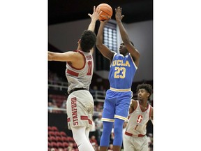 UCLA guard Prince Ali (23) shoots over Stanford guard Dorian Pickens (11) during the first half of an NCAA college basketball game Thursday, Jan. 4, 2018, in Stanford, Calif.