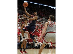 Arizona guard Parker Jackson-Cartwright (0) drives to the basket against Stanford forward Reid Travis (22) during the first half of an NCAA college basketball game Saturday, Jan. 20, 2018, in Stanford, Calif.