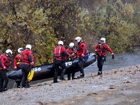 A rescue team removes their boat after a swift water rescue in the Los Angeles River early Tuesday, Jan. 9, 2018  at Lake Balboa in Los Angeles.  Crews rescued residents from inundated homes Tuesday as mud and debris from wildfire-scarred hillsides flowed through neighborhoods and onto a key Southern California highway during a powerful winter storm that dropped record rain across the state.