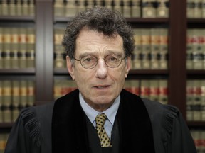 Judge Dan Polster poses in his office, Thursday, Jan. 11, 2018, in Cleveland. Polster has invited Ohio's attorney general Mike DeWine to brief him on the impact of the opioid epidemic. Polster is overseeing a consolidated case involving dozens of lawsuits filed by communities around the country against drugmakers and drug distributors.