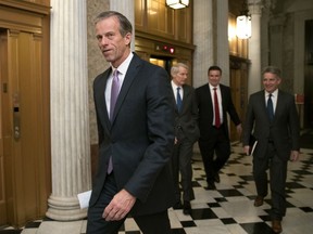 FILE - In this Dec. 18, 2017, file photo, Sen. John Thune, R-S.D., heads to a meeting at the Capitol in Washington. Key senators and farm groups are trying to fix a provision in the federal tax overhaul that gave an unexpected tax break to farmers who sell their crops to cooperatives instead of private buyers. The provision from Thune and John Hoeven, R-N.D., surfaced in the final days of the debate over the tax bill, which President Donald Trump signed last month.