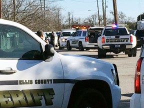 Law enforcement personnel from the Ellis County Sheriff's Office park outside a high school in Italy, Texas, following an active shooter incident at the school Monday morning, Jan. 22, 2018. Sheriff's officials said a boy who is a student at the school was taken into custody.