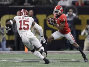 Georgia's Terry Godwin catches a pass in front of Alabama's Ronnie Harrison during the first half of the NCAA college football playoff championship game Monday, Jan. 8, 2018, in Atlanta.