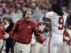 Alabama head coach Nick Saban talks to Bo Scarbrough during the first half of the NCAA college football playoff championship game against Georgia Monday, Jan. 8, 2018, in Atlanta.
