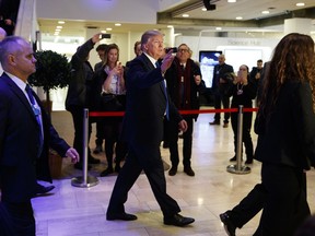 President Donald Trump waves as he walks to a dinner with European business leaders at the World Economic Forum, Thursday, Jan. 25, 2018, in Davos.
