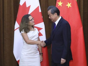 Canadian Foreign Minister Chrystia Freeland, left, is greeted by China's Foreign Minister Wang Yi as she arrives for a meeting at the Ministry of Foreign Affairs in Beijing, Wednesday, Aug. 9, 2017.
