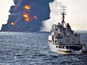 In this Sunday, Jan. 14, 2018, photo provided by China's Ministry of Transport, a rescue ship sails near the burning Iranian oil tanker Sanchi in the East China Sea off the eastern coast of China.