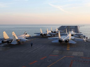 A photo taken in December 2016 shows Chinese J-15 fighter jets on the deck of the Liaoning aircraft carrier during military drills in the Bohai Sea, off China's northeast coast.