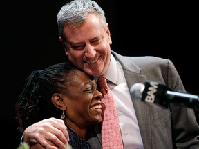 New York City Mayor Bill de Blasio hugs his wife, Chirlane McCray, at a tribute to Martin Luther King, Jr. in Brooklyn on Jan. 20, 2014.
