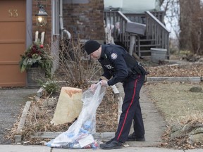 A police officer is shown outside a house on Mallory Crescent in Toronto, where Bruce McArthur did landscape work, on Monday, January 29 , 2018. McArthur, 66, was charged Jan. 18 in the presumed deaths of Selim Esen and Andrew Kinsman. He was further charged on Monday in the deaths Majeed Kayhan, 58, Soroush Mahmudi, 50, and Dean Lisowick, 47.