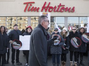 President of Ontario Federation of Labour Chris Buckley addresses protesters outside a Tim Hortons Franchise in Toronto on Wednesday January 10, 2018. Labour organizations across Ontario are holding rallies today to protest the actions some Tim Hortons franchises have taken in response to an increase in the province's minimum wage.