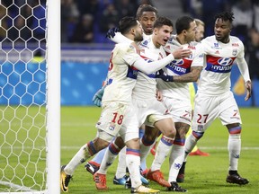 Lyon's players celebrate after Nabil Fekir, left, scored a goal against Angers during their French League One soccer match in Decines, near Lyon, central France, Sunday, Jan. 14, 2018.