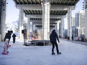 Members of the local community skate in a media preview of the Bentway Skate Trail, a 220 metre ribbon of ice running under a section of the Gardiner Expressway, in Toronto, on Friday, January 5, 2018.