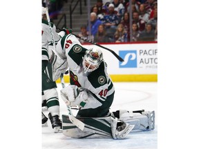 Minnesota Wild goaltender Devan Dubnyk reels back as he deflects aColorado Avalanche shot during the first period of an NHL hockey game Saturday, Jan. 6, 2018, in Denver.