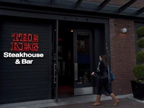 A woman walks into a Keg Steakhouse and Bar in Yaletown in downtown Vancouver, B.C. Tuesday, Nov.19, 2013. Cara Operations Ltd. has signed an agreement to acquire Keg Restaurants Ltd. in a deal worth at least $200 million in shares and cash.