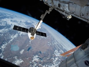 The Canadarm 2 reaches out to capture the SpaceX Dragon cargo spacecraft and prepare it to be pulled into its port on the International Space Station on April 17, 2015. The Canadian Space Agency says it used a "creative software solution" to fix a replacement part on the Canadarm 2, postponing the need to send astronauts on a spacewalk. The agency says scientists detected an anomaly in one of the electronic systems that controls a new hand that was installed on the International Space Station's robotic arm last Tuesday. THE CANADIAN PRESS/AP, NASA