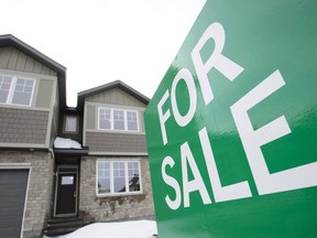 A for sale sign is shown outside a house under construction in a new subdivision in Beckwith, Ont., on Wednesday, Jan. 11, 2018. The Canadian Real Estate Assocation says national home sales rose 4.5 per cent in December from the month before.