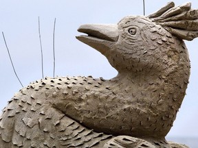 Wires poke from the detail of a bird, to detract actual birds from landing, on a sand sculpture titled "Seduction" by Michel Lepire, of Quebec, on Hampton Beach in Hampton, N.H., Friday, June 16, 2017. Quebec ice and sand sculptor Michel Lepire, the man behind many of the elaborate ice palaces at Quebec City's annual Carnaval, has died.