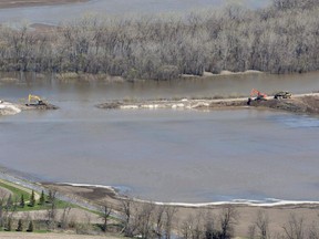 The breach in the dike at the hoop and holler bend is seen along the Assiniboine River outside of Portage La Prairie, Man, Saturday, May 14, 2011. A settlement approval hearing is scheduled for a $90-million settlement stemming from a class action lawsuit launched by Lake St. Martin, Pinaymootang (Fairford), Little Saskatchewan and Dauphin River First Nations against the federal and provincial governments over 2011 flooding.