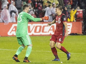 Toronto FC goalkeeper Alex Bono (25) celebrates with teammate Nick Hagglund at the final whistle as they beat the New York Red Bulls on away goals to win the MLS Eastern Conference semifinal in Toronto on Sunday, November 5, 2017. Major League Soccer's SuperDraft, always a crapshoot, is more complicated than ever this year. Looking at Toronto FC's current roster _ like other clubs, very much a work in progress during the off-season _ only goalkeeper Alex Bono (sixth overall, 2015) and defender Nick Hagglund (10th overall, 2014) remain among Toronto draft choices.