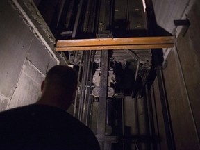 A building manager is pictured in an elevator shaft in a downtown Toronto office building on Wednesday, July 13, 2016. A report on elevator availability in Ontario is expected to be released on Thursday, along with the government's comprehensive plan to address all 19 recommendations in the study.THE CANADIAN PRESS/Chris Young