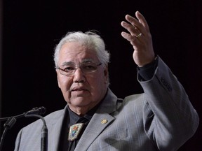 Commission chairman Justice Murray Sinclair raises his arm asking residential school survivors to stand at the Truth and Reconciliation Commission in Ottawa on June 2, 2015. Former Truth and Reconciliation Commission chairman Sinclair says it is critical for federal, territorial and provincial officials involved in child welfare across the country to get on with addressing the over-representation of Indigenous kids in the system and devastating impacts associated with it.