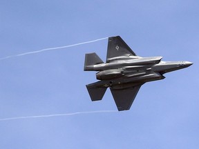 In this Wednesday, Sept. 2, 2015, file photo, an F-35 jet arrives at its new operational base at Hill Air Force Base, in northern Utah. Six years after his explosive report on the F-35 derailed the Harper government's plan to buy the controversial stealth aircraft, federal auditor general Michael Ferguson is diving back into the fighter-jet file.