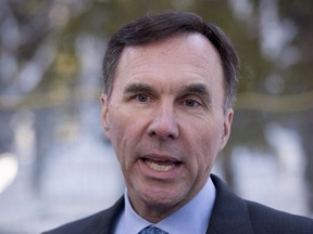 Finance Minister Bill Morneau talks to reporters on the grounds of the World Economic Forum Wednesday, January 24, 2018 in Davos, Switzerland. Morneau was inundated with more than 10,000 missives last fall following the release of controversial tax-change proposals that enraged Canada's small-business community.