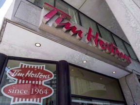 A Tim Hortons coffee shop is shown in Toronto on Wednesday, June 29, 2016. Tim Hortons' Canadian headquarters has waded into a brewing controversy stemming from this week's minimum wage hike in Ontario, calling the elimination of paid breaks and benefits for employees at certain locations "reckless".